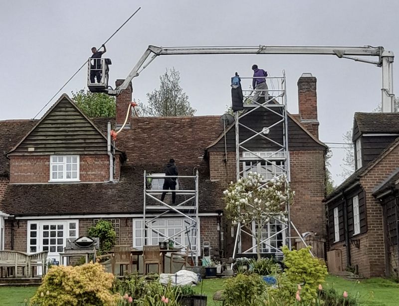 The Moss Cleaners using cherry picker and scaffolding to clean roof safely and professionally in 21 Church Rd, Teddington TW11 8PF, UK, 21 Church Rd, Teddington TW11 8PF, UK